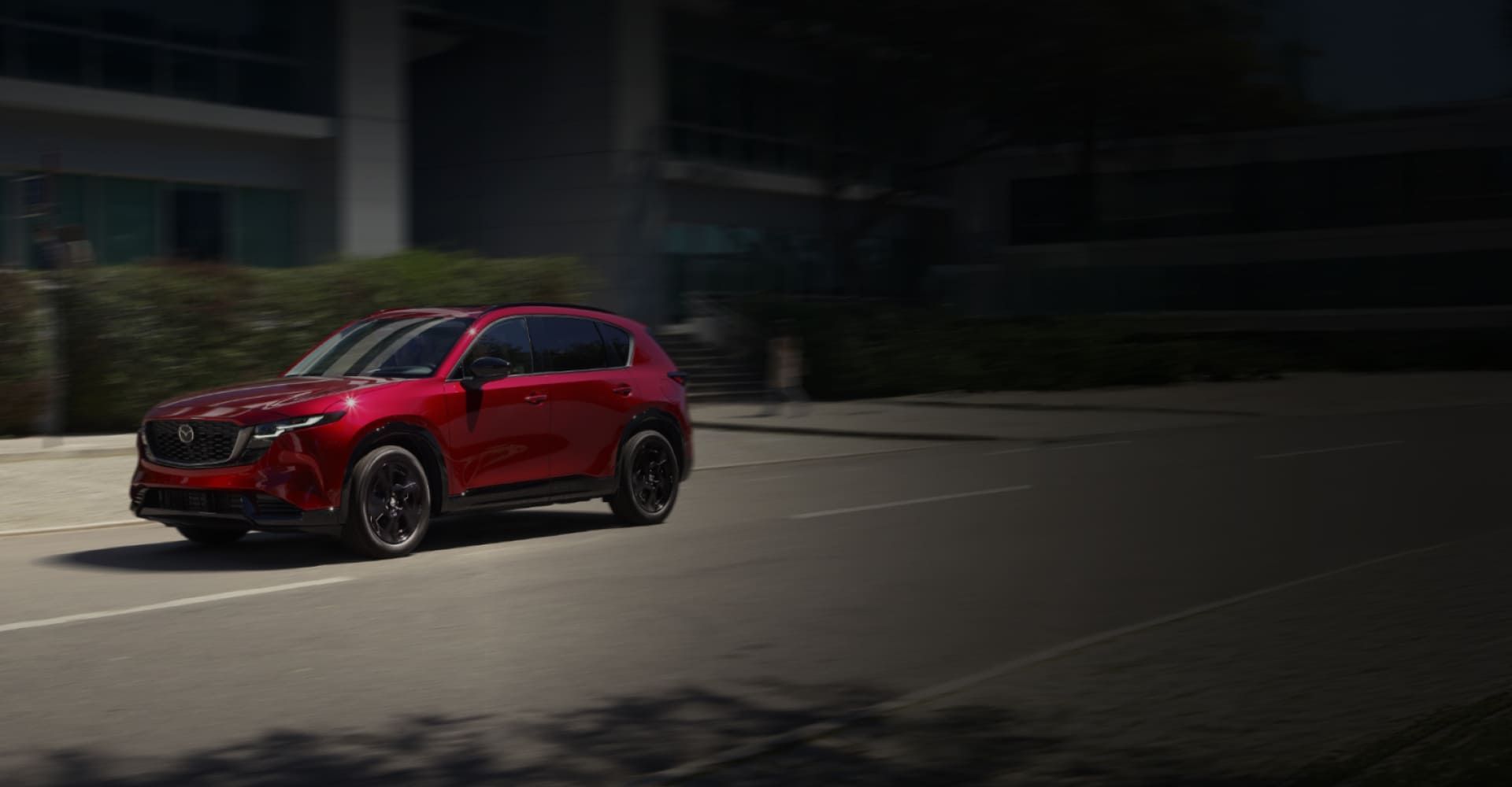Red 2026 Mazda CX-5 driving through the city