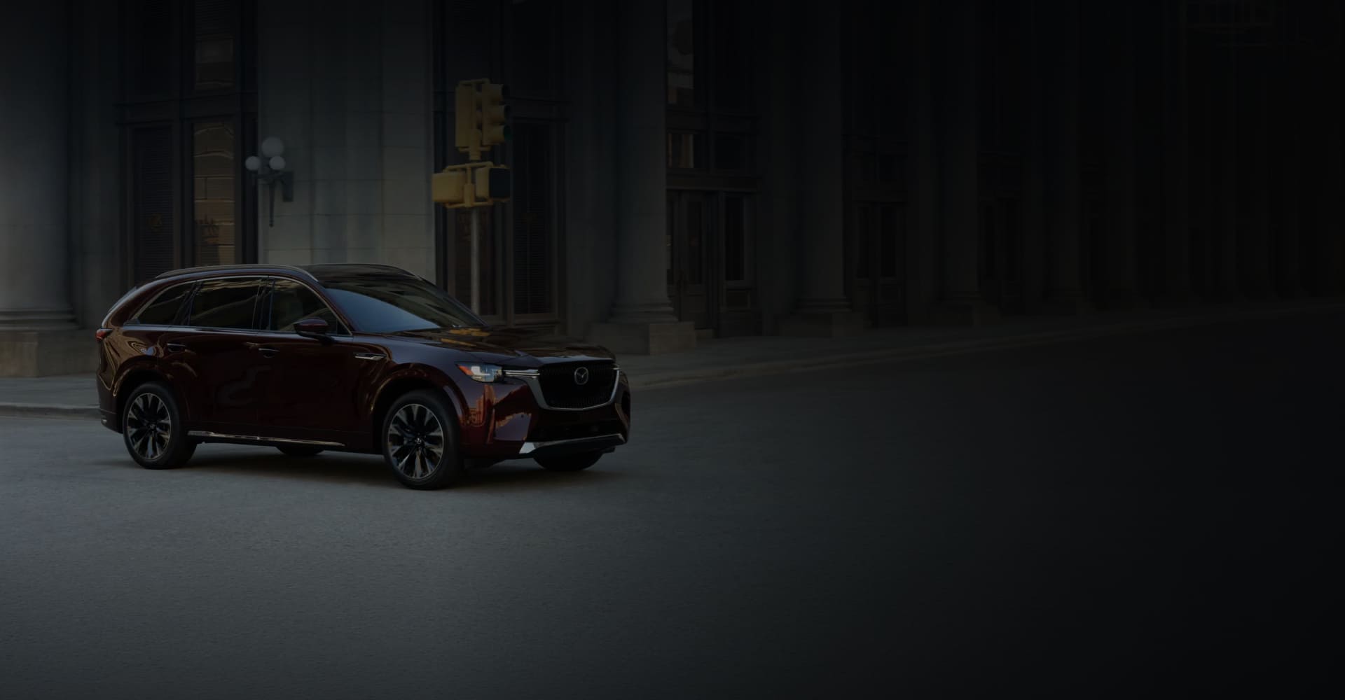 Red 2026 Mazda CX-90 on a dark city street
