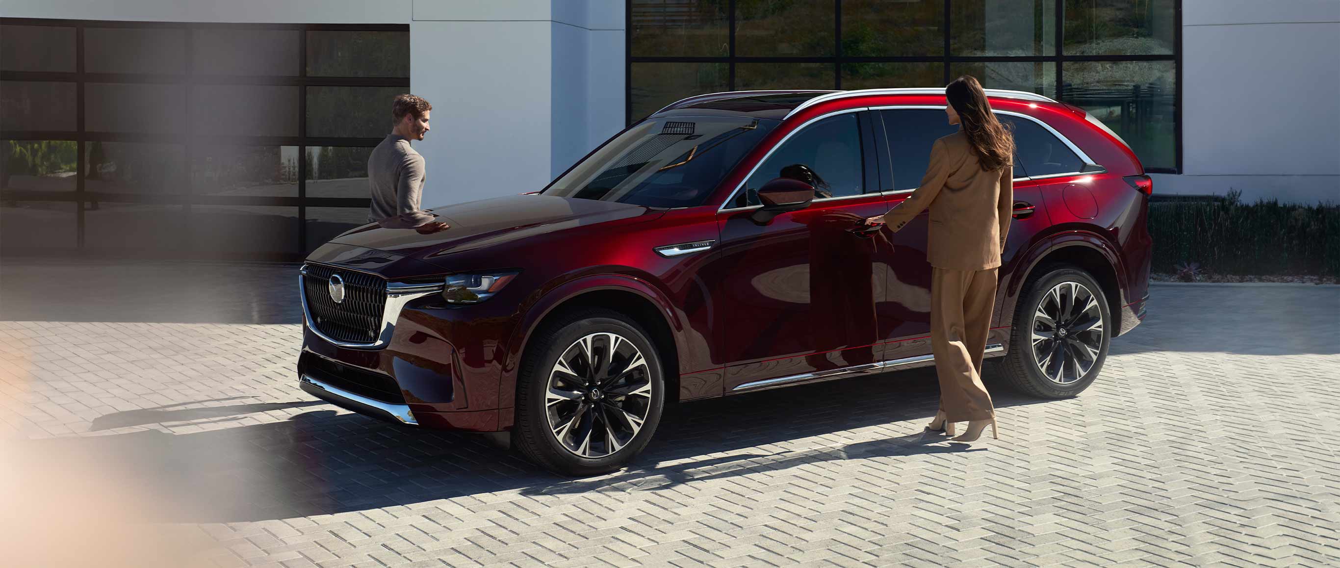 Red 2026 Mazda CX-90 with passengers