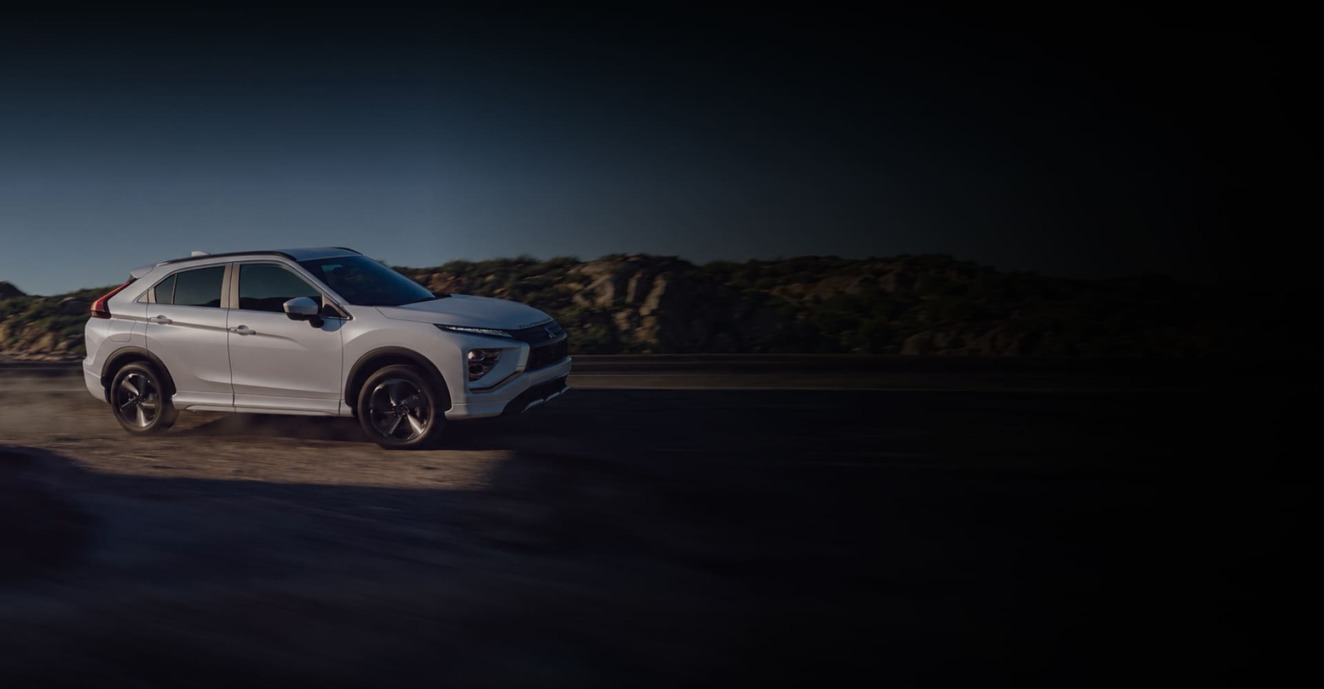 White Mitsubishi Eclipse Cross driving along a desert road