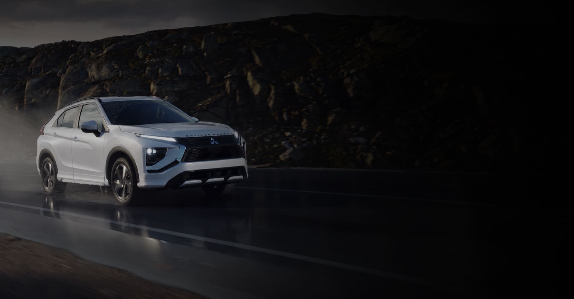 White 2026 Mitsubishi Eclipse Cross driving on a wet road