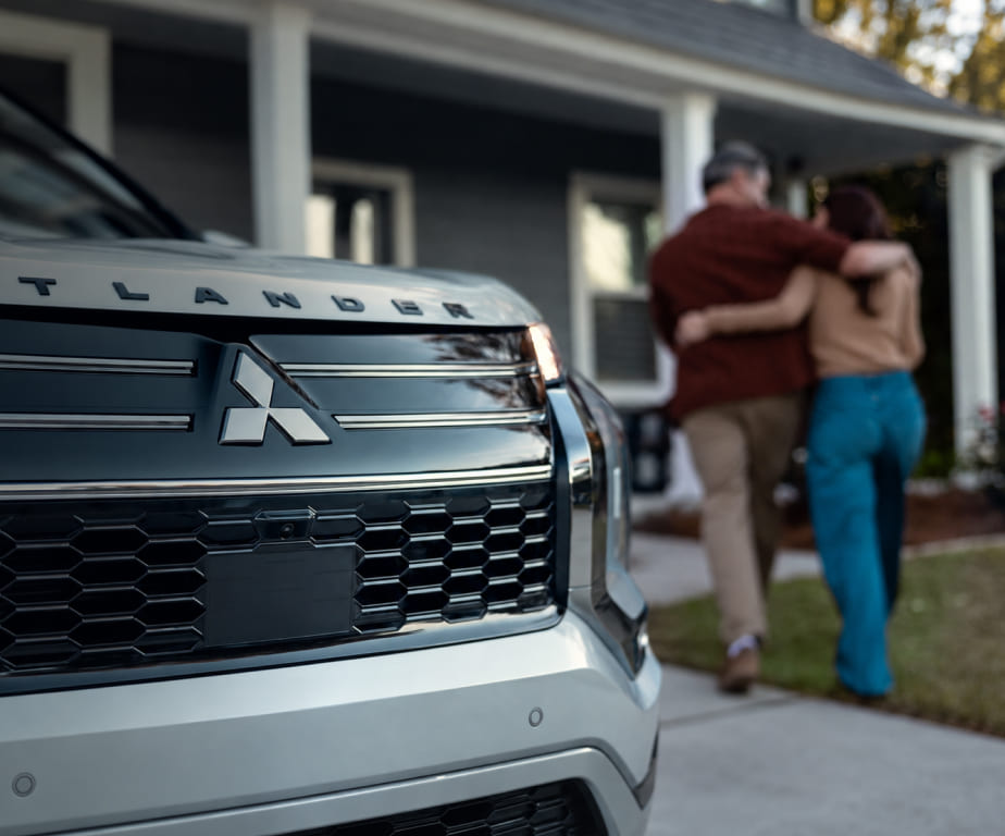 Front grille of a Mitsubishi Outlander outside a home